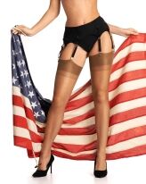 Bottom half close-up of black lingerie, stocking with garter belt, holding an American flag against a white background.